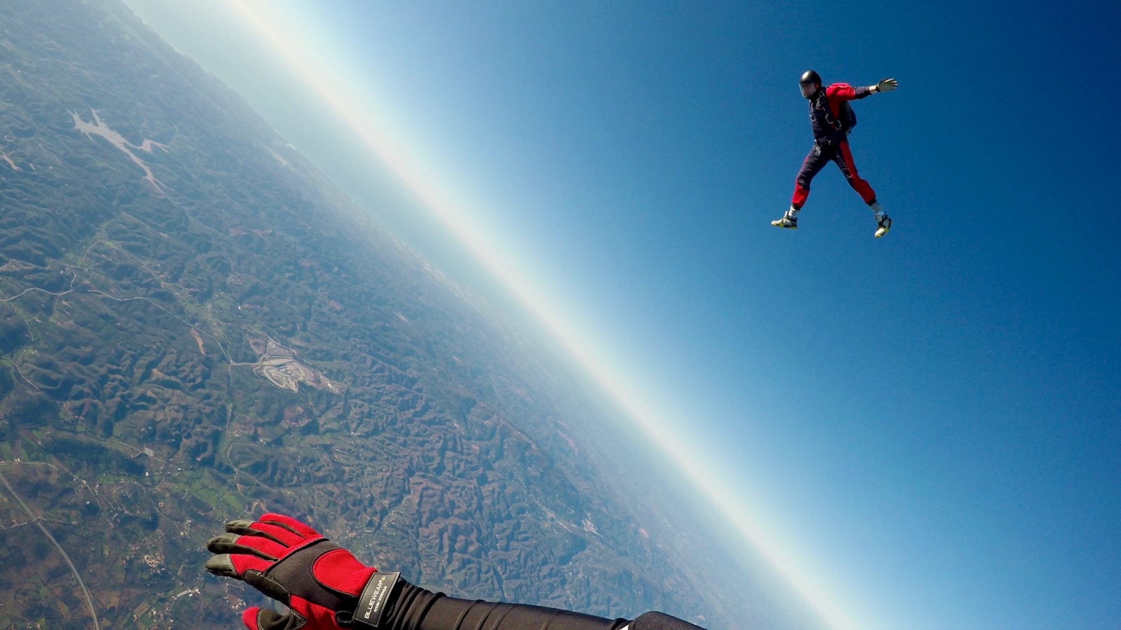 man in red and black outfit air diving